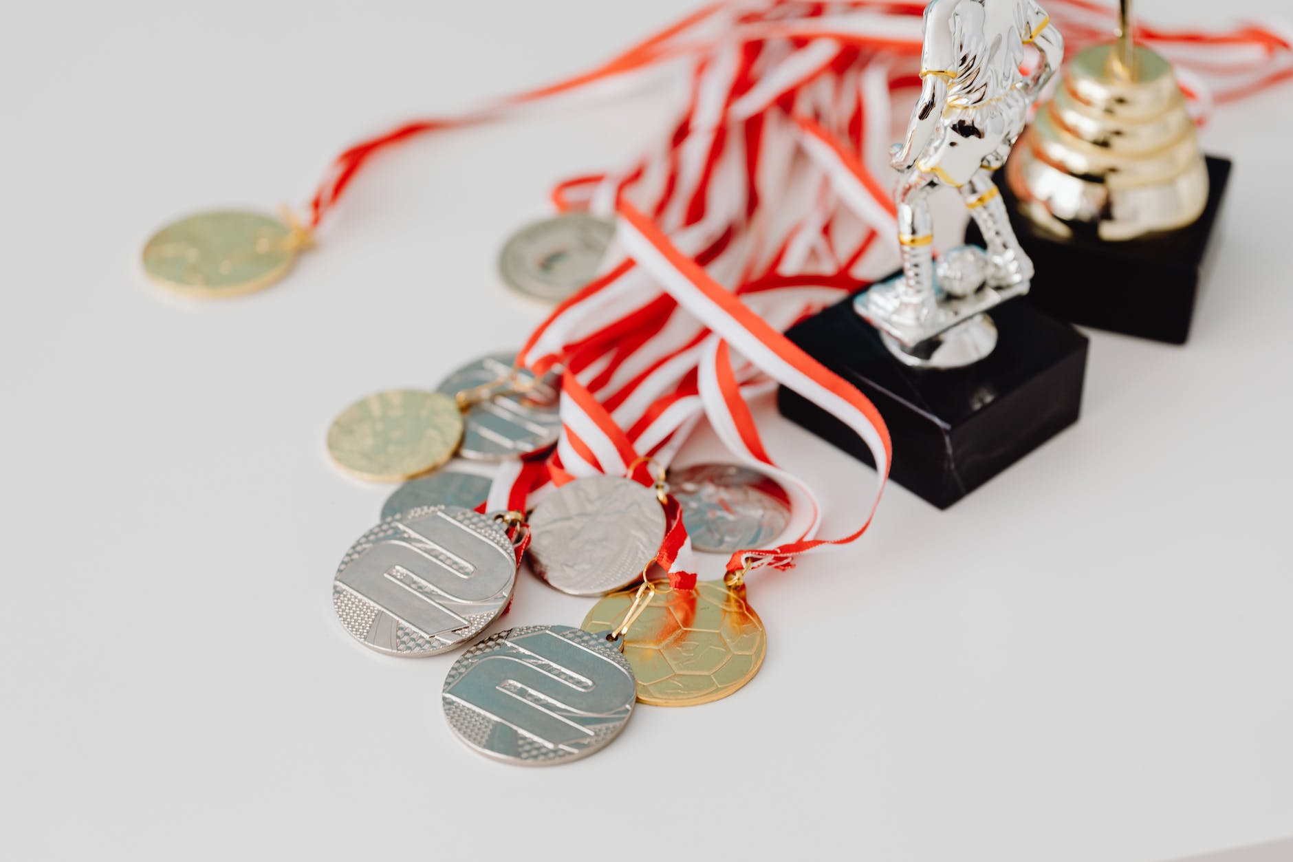 pile of sport medals on table